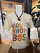 Mannequin wearing a t-shirt with colorful text in a store setting